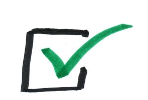 A black outlined checkbox with a bold green checkmark inside, set against a white background.
